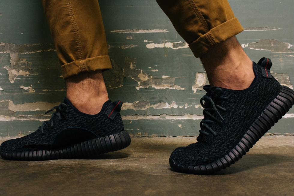 Black yeezy on store feet